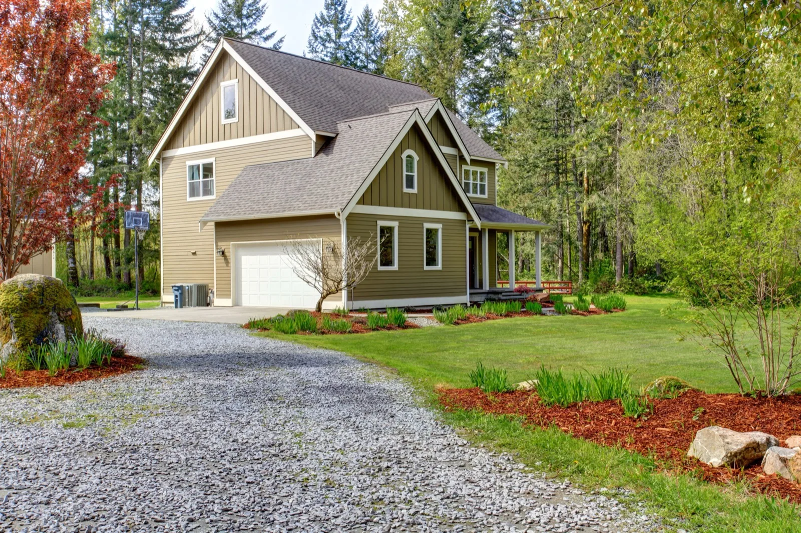 Finished gravel driveway leading to a house
